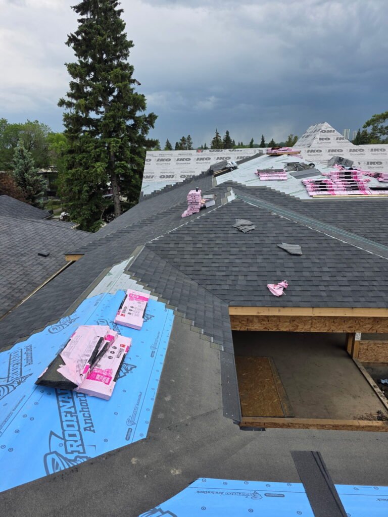 Roof replacement in progress on a Calgary home with new underlayment and shingles