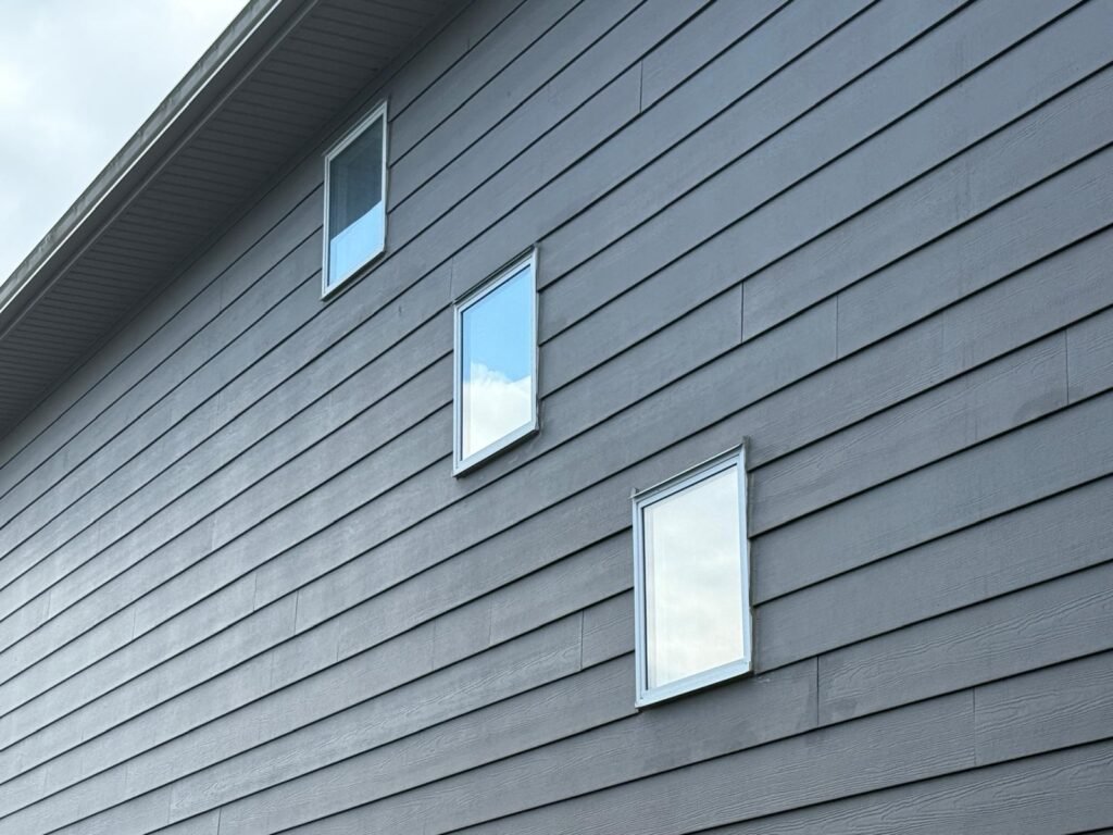 New grey lap siding installed on a Calgary home